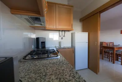a kitchen with a stove and a refrigerator at Eden Vilage by Garvetur in Vilamoura