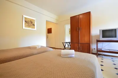 a hotel room with two beds and a tv at Rio by Garvetur in Vilamoura