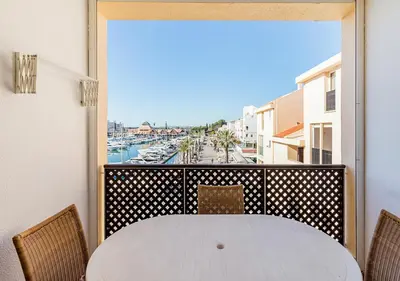 a kitchen with gray cabinets and a sink and a window at Marina Plaza by Garvetur in Vilamoura