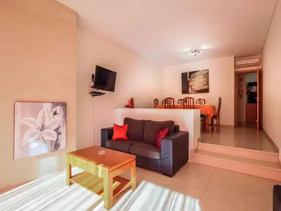 a living room with a couch and a table at V4, Villa Jardins Branqueira4 near Beach, Albufeira in Albufeira