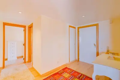 a white room with a desk and two windows at São Vicente - 1Br - Facing to Marina in Quarteira