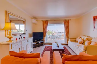 a living room with a couch and a tv at São Vicente - 1Br - Facing to Marina in Quarteira