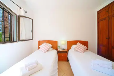 two twin beds in a room with a window at 2 Bed Ground Floor Apartment In Vilamoura in Vilamoura