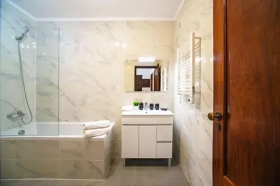 a bathroom with a tub and a sink and a shower at 2 Bed Ground Floor Apartment In Vilamoura in Vilamoura