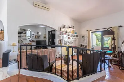 a room with a balcony with a table and chairs at Villa Morena in Albufeira