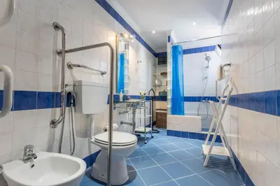 a blue and white bathroom with a toilet and a sink at Villa Morena in Albufeira
