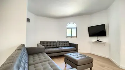 a living room with a couch and a tv at Villa Palmeira Galé Beach in Albufeira