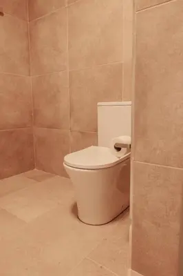 a bathroom with a white toilet in a room at Casa Velha Apartments - Adults friendly in Albufeira