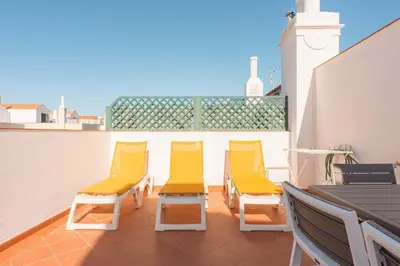 a group of yellow chairs on a balcony at Old Village & Prestige in Vilamoura
