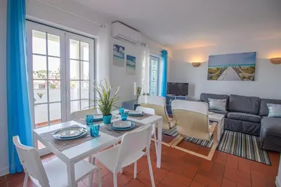 a living room with a table and chairs and a couch at Old Village & Prestige in Vilamoura