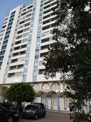 a large building with cars parked in front of it at Sea View urban apartment in Faro
