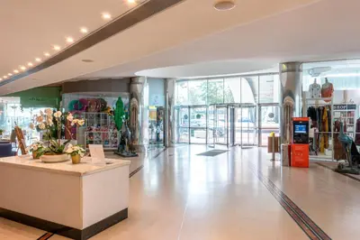 a lobby with couches and people sitting at tables at Hotel Apartamento Paraiso De Albufeira in Albufeira