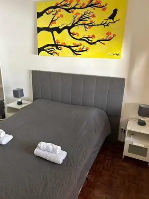 a bedroom with a bed with two towels on it at Brother´s House in Faro