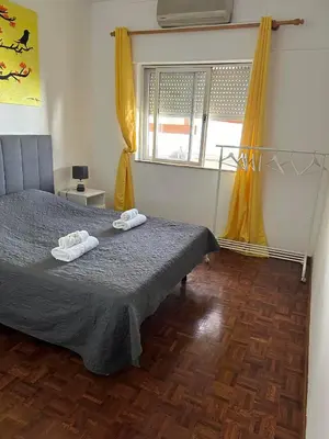 a bedroom with a bed with two towels on it at Brother´s House in Faro