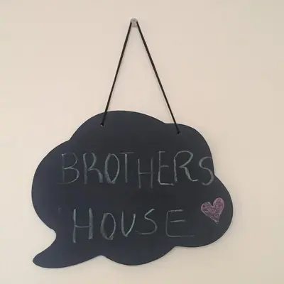 a black sign with the words brothers house at Brother´s House in Faro