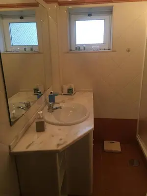 a bathroom with a sink and a mirror at Brother´s House in Faro
