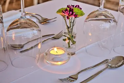 a table with a candle and a vase with flowers at Quinta Jacintina - My Secret Garden Hotel in Vale do Lobo