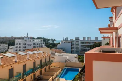 arial view of a city with buildings and a swimming pool at Apartamentos Monte da Vinha I in Albufeira