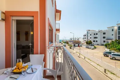 a balcony with a table and a view of a street at Apartamentos Monte da Vinha I in Albufeira