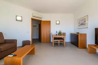 a living room with a couch and a table at Apartamentos Turisticos Monte da Vinha II in Albufeira
