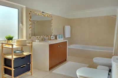 a bathroom with a sink and a toilet and a tub at Villa Francella- Relaxing holidays in an ideal location by DreamvillasAlbufeira in Albufeira