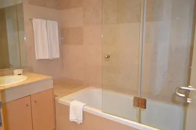 a bathroom with a shower with a tub and a sink at Residence Golf Club by Garvetur in Vilamoura