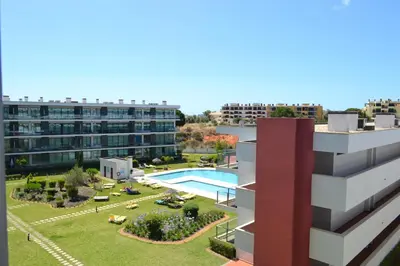 an aerial view of a building with a swimming pool at Residence Golf Club by Garvetur in Vilamoura