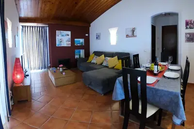 a living room with a couch and a table at LOTUS VILLA, Albufeira in Albufeira