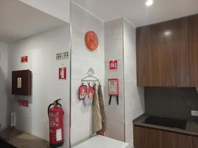a kitchen with a red fire hydrant on a wall at Charming Apartment in Quarteira - 50 m² - Terrace in Quarteira
