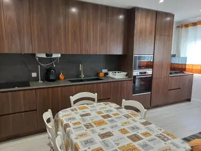 a kitchen with a table and chairs in a kitchen at Charming Apartment in Quarteira - 50 m² - Terrace in Quarteira