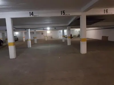 an empty parking lot with columns in a parking garage at Apartment Girasol Front Beach Quarteira Algarve in Quarteira