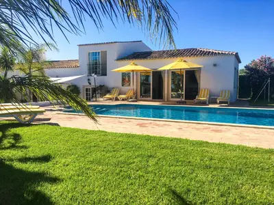 a villa with a swimming pool and a house at Quinta Da Ilda in Loulé