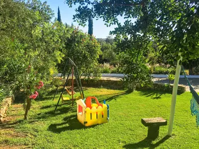 a garden with a swing set and a playground at Quinta Da Ilda in Loulé