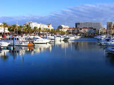 a group of boats docked in a marina with buildings at Spacious apartment in Albufeira 80 m² with shared pool in Roja- Pé