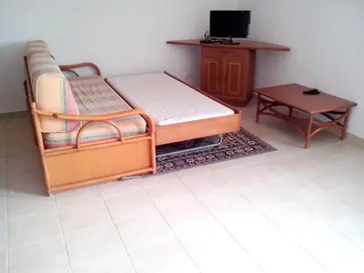 a bedroom with a bed and a table and a tv at Welcoming apartment in Albufeira 60 m² with shared pool in Albufeira