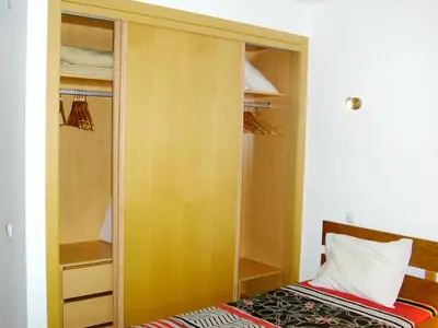 a closet with a bed in a room at Charming apartment with shared pool in Albufeira - 60 m² in Albufeira