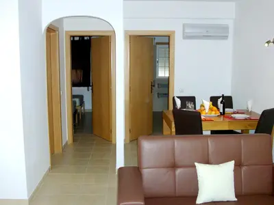 a living room with a couch and a table at Charming apartment with shared pool in Albufeira - 60 m² in Albufeira
