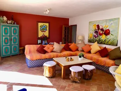 a living room with two couches and a table at FARMHOUSE CASA DA AVÓ in Loulé