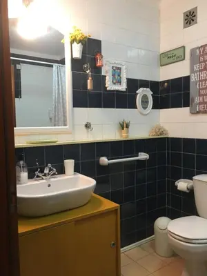 a bathroom with a sink and a toilet at Casa da Bia in Quarteira