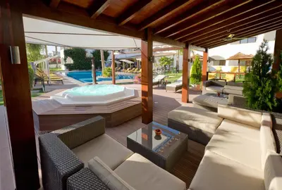 an outdoor patio with couches and a swimming pool at Cerro Da Marina Hotel - Adults Only in Albufeira