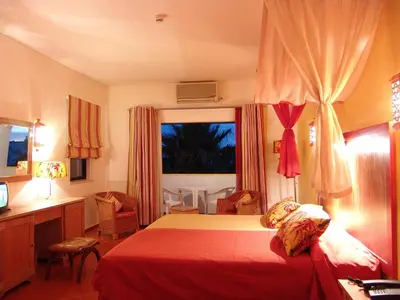 a bedroom with a bed and a desk and a window at Cerro Da Marina Hotel - Adults Only in Albufeira