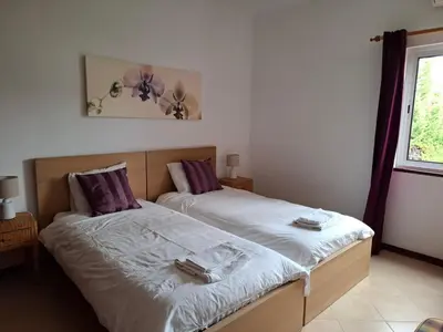 a bedroom with two beds and a window at Villa Alexia - By Algarkasa in Albufeira