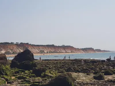 a group of people on a beach near the water at Villa Alexia - By Algarkasa in Albufeira