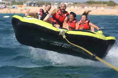 a group of people in a boat in the water at Apartamento com Piscina em Albufeira, Praia da Oura in Albufeira