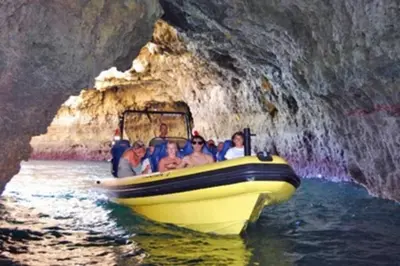 a group of people in a yellow boat in a cave at Apartamento com Piscina em Albufeira, Praia da Oura in Albufeira