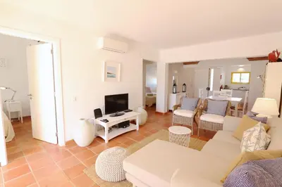 a living room with a couch and a tv at Aldeia do Golf 151 - Clever Details in Vilamoura