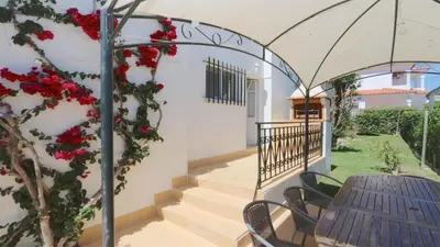 a balcony with a table and red flowers at Villa Amelia 156 - Clever Details in Vilamoura