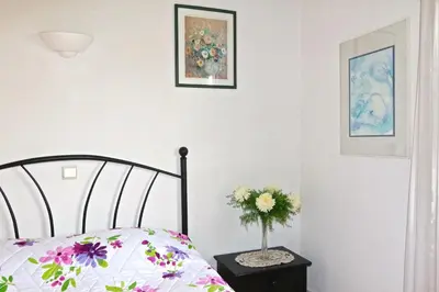 a bedroom with a bed and a vase of flowers at Villa Amelia 156 - Clever Details in Vilamoura