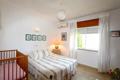 a white bedroom with a bed and a window at Villa Amelia 156 - Clever Details in Vilamoura
