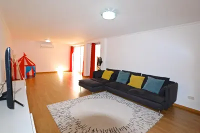 a living room with a couch and a rug at Villa Gustas 150 - Clever Details in Vilamoura